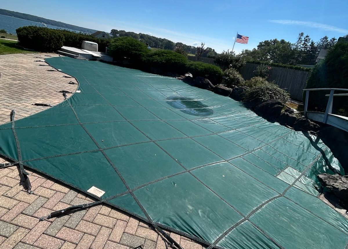 A mesh safety cover fitted to a pool
